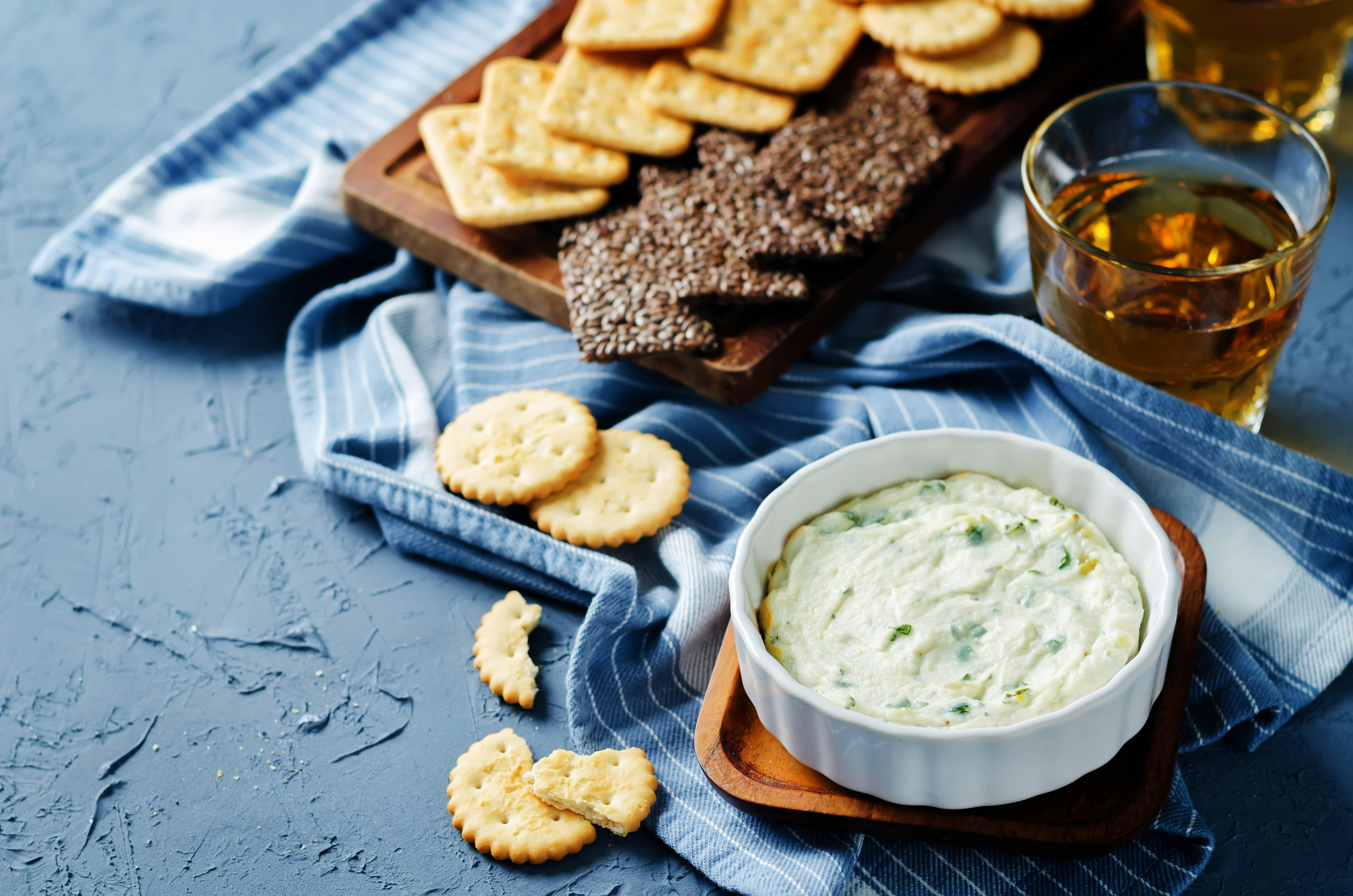 Parsley garlic warm ricotta cheese dip on a stone background. toning. selective focus
